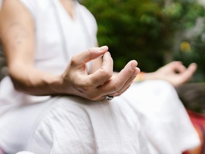 Close up of hands in mudra position.