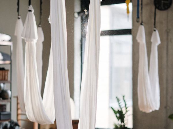 Person practicing yoga in a dark aesthetic studio.